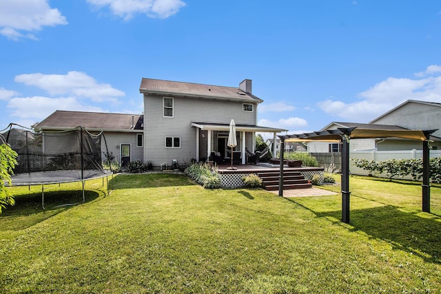 4202 Courtney St, Saint Joseph, MI 49085 - back of property featuring a trampoline, a deck, and a chimney