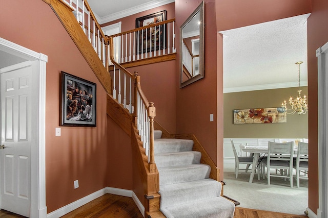 4202 Courtney St, Saint Joseph, MI 49085 - stairs featuring wood finished floors, a chandelier, and crown molding