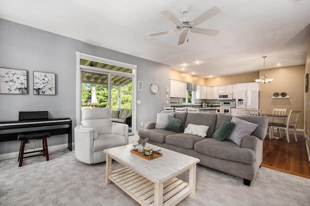 4202 Courtney St, Saint Joseph, MI 49085 - living room featuring a ceiling fan, a chandelier, recessed lighting, and light carpet
