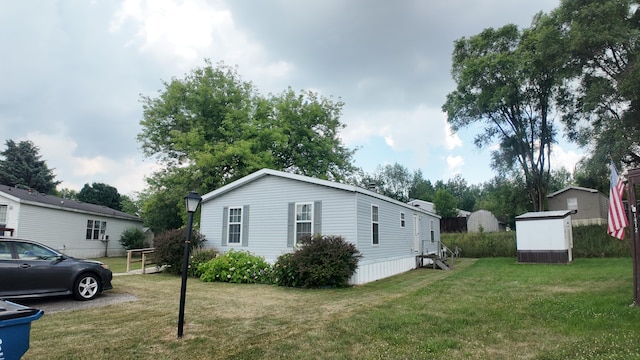 1410 Country View Ct NW, Sparta, MI 49345 - view of property exterior with a storage shed and a yard