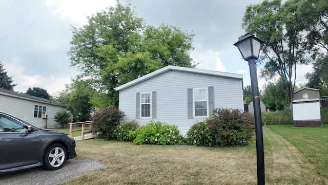 1410 Country View Ct NW, Sparta, MI 49345 - view of home's exterior featuring a lawn and a storage shed
