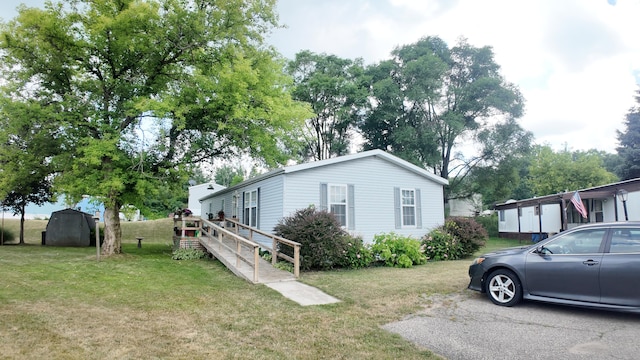 1410 Country View Ct NW, Sparta, MI 49345 - view of home's exterior featuring a storage shed and a yard