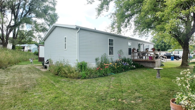 1410 Country View Ct NW, Sparta, MI 49345 - view of property exterior featuring a yard and a wooden deck