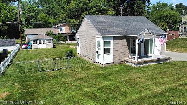 4685 Downing Dr, Pinckney, MI 48169 - view of front of house with a fenced backyard, a gate, an outdoor structure, and roof with shingles