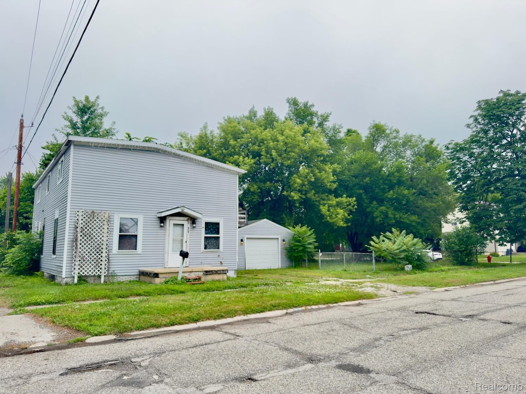 909 Elmwood St, Port Huron, MI 48060 - view of front of house featuring a garage