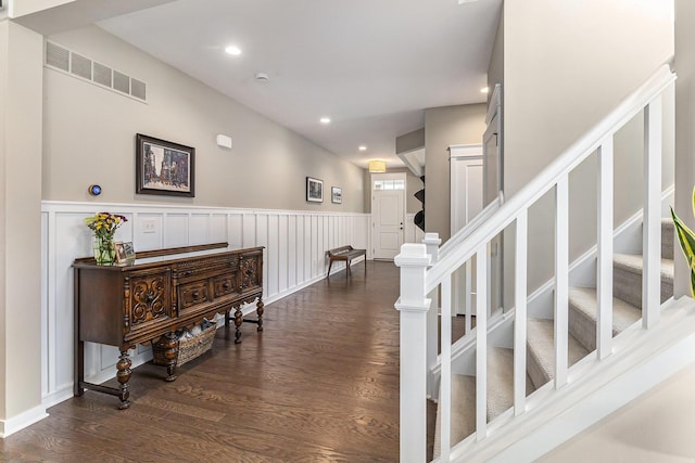 6217 S Trailwoods Dr, Ann Arbor, MI 48103 - hall with stairway, dark wood-type flooring, wainscoting, recessed lighting, and a decorative wall