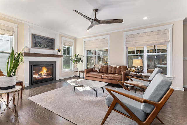 6217 S Trailwoods Dr, Ann Arbor, MI 48103 - living room with crown molding, a fireplace with flush hearth, a ceiling fan, dark wood-type flooring, and recessed lighting