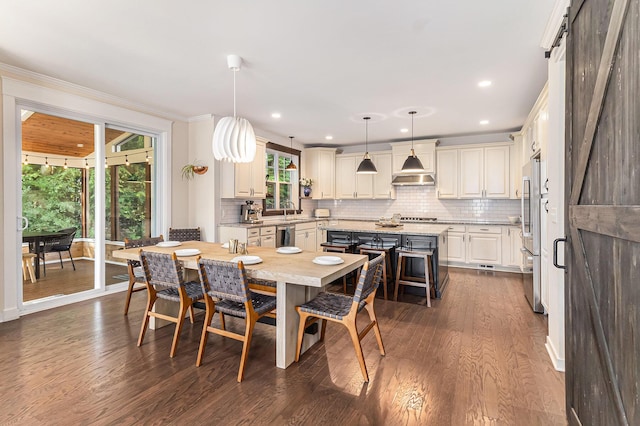 6217 S Trailwoods Dr, Ann Arbor, MI 48103 - dining space featuring dark wood-style flooring, ornamental molding, and recessed lighting