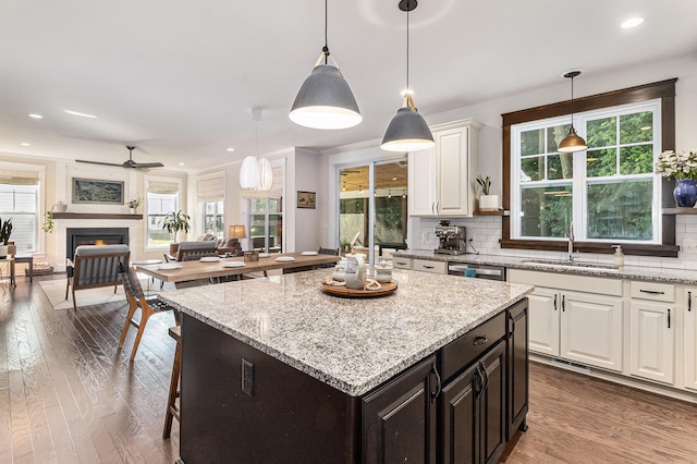 6217 S Trailwoods Dr, Ann Arbor, MI 48103 - kitchen featuring white cabinetry, wood finished floors, open floor plan, decorative backsplash, and recessed lighting