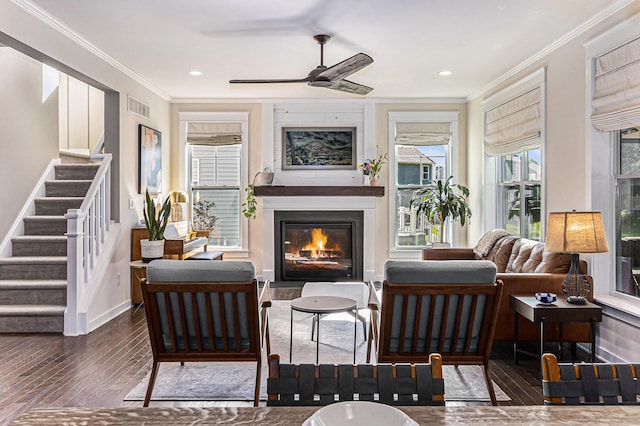 6217 S Trailwoods Dr, Ann Arbor, MI 48103 - living room featuring ornamental molding, wood-type flooring, ceiling fan, stairway, and a glass covered fireplace