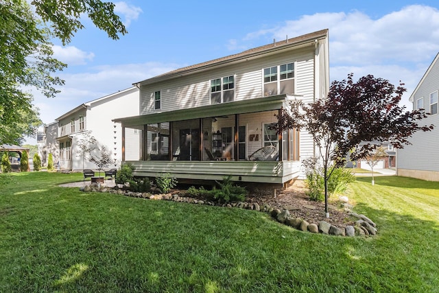 6217 S Trailwoods Dr, Ann Arbor, MI 48103 - back of property featuring a sunroom and a yard
