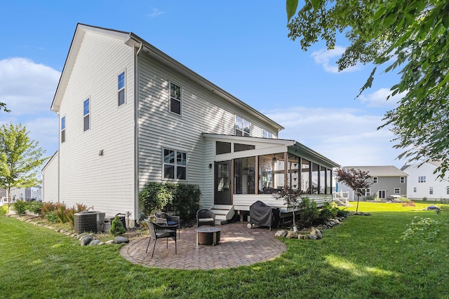 6217 S Trailwoods Dr, Ann Arbor, MI 48103 - back of house featuring a sunroom, a lawn, and a patio area