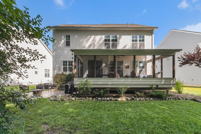 6217 S Trailwoods Dr, Ann Arbor, MI 48103 - back of house with a sunroom, a patio area, and a lawn