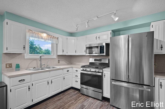 4305 76th St SW, Byron Center, MI 49315 - kitchen featuring appliances with stainless steel finishes, light countertops, white cabinets, a textured ceiling, and track lighting