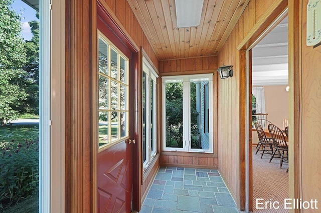 4305 76th St SW, Byron Center, MI 49315 - entryway featuring stone tile floors, plenty of natural light, and wood walls