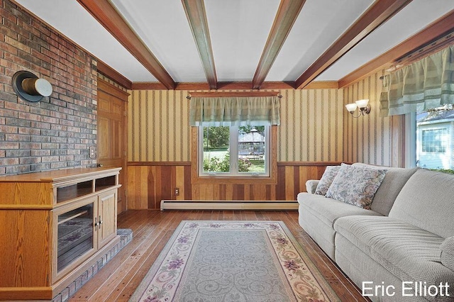 4305 76th St SW, Byron Center, MI 49315 - living room featuring baseboard heating, wood-type flooring, beam ceiling, healthy amount of natural light, and wainscoting