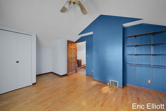 4305 76th St SW, Byron Center, MI 49315 - unfurnished bedroom featuring lofted ceiling, wood finished floors, and ceiling fan