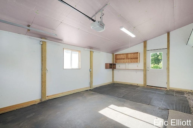 4305 76th St SW, Byron Center, MI 49315 - garage featuring a garage door opener and baseboards