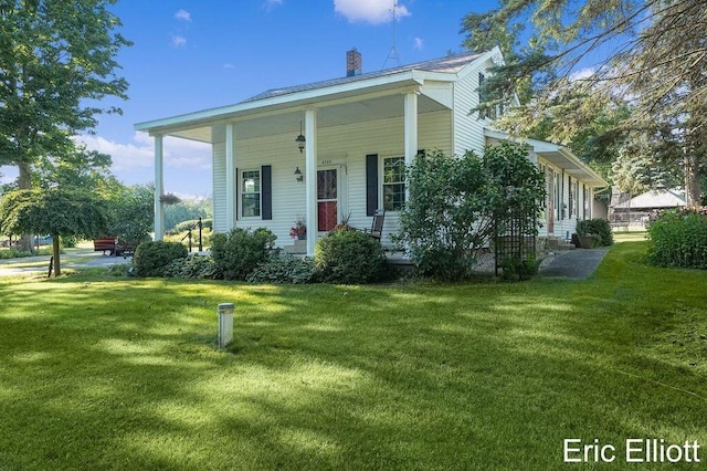 4305 76th St SW, Byron Center, MI 49315 - view of front of property with a front lawn, a chimney, and a porch