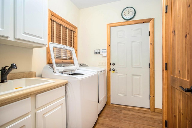 11463 Snowshoe Dr, Plainwell, MI 49080 - laundry room featuring cabinet space, washing machine and clothes dryer, and light wood finished floors