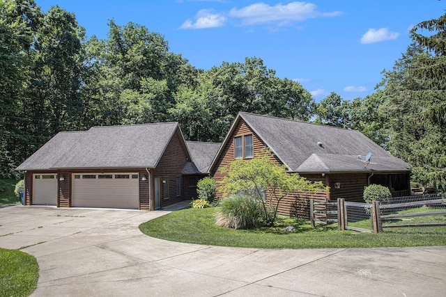 11463 Snowshoe Dr, Plainwell, MI 49080 - view of front of home featuring a garage, concrete driveway, an outbuilding, and a shingled roof