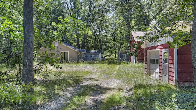 2267 Caberfae Hwy, Manistee, MI 49660 - view of yard featuring a garage and an outbuilding