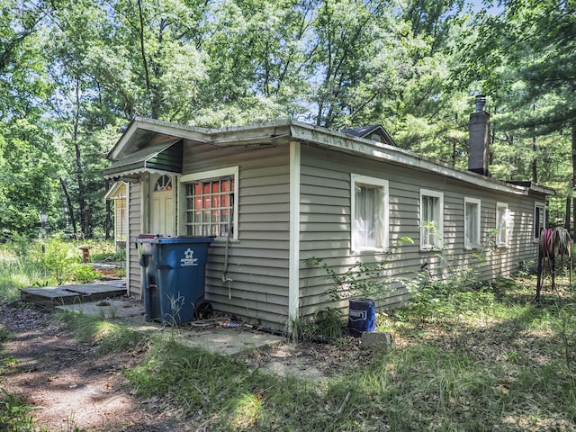 2267 Caberfae Hwy, Manistee, MI 49660 - view of property exterior featuring a chimney
