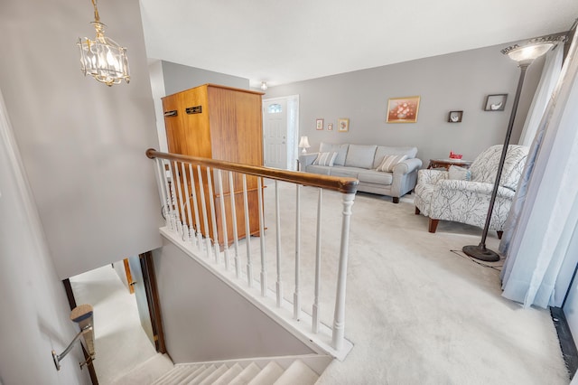 18165 Shamrock Blvd, Big Rapids, MI 49307 - stairs with carpet and a chandelier