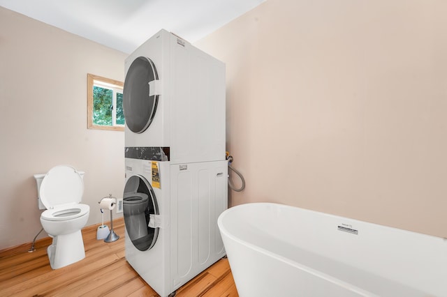 18165 Shamrock Blvd, Big Rapids, MI 49307 - laundry room with stacked washer / drying machine and light wood-style floors