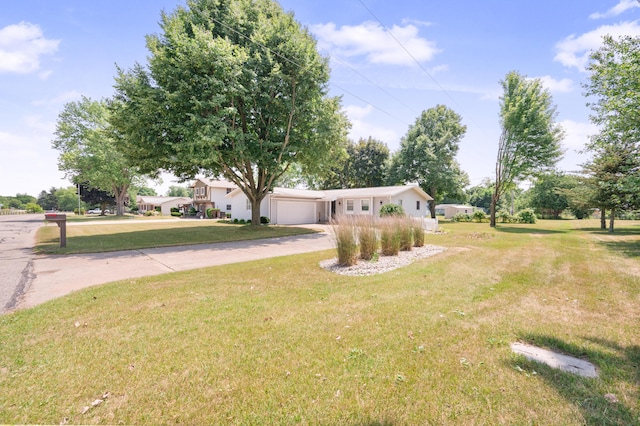 18165 Shamrock Blvd, Big Rapids, MI 49307 - ranch-style house with concrete driveway, a front lawn, and a garage