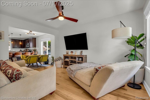 1305 Wyandotte Ave, Royal Oak, MI 48067 - living room featuring a ceiling fan and light wood-type flooring