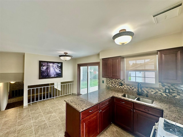 25631 Statler St, Taylor, MI 48180 - kitchen featuring decorative backsplash, range, healthy amount of natural light, and a peninsula