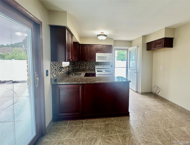 25631 Statler St, Taylor, MI 48180 - kitchen featuring white appliances, backsplash, a peninsula, and dark brown cabinetry