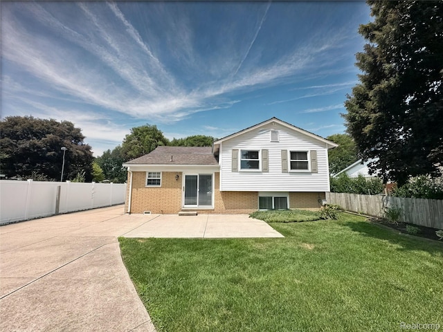 25631 Statler St, Taylor, MI 48180 - back of property featuring a patio area, a fenced backyard, brick siding, and concrete driveway