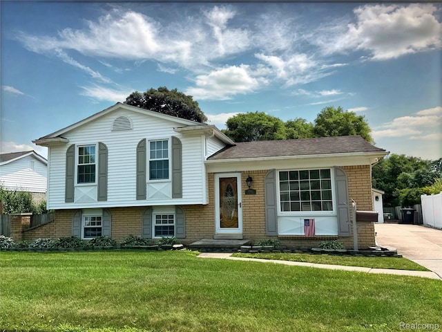 25631 Statler St, Taylor, MI 48180 - split level home featuring brick siding, driveway, and a garage
