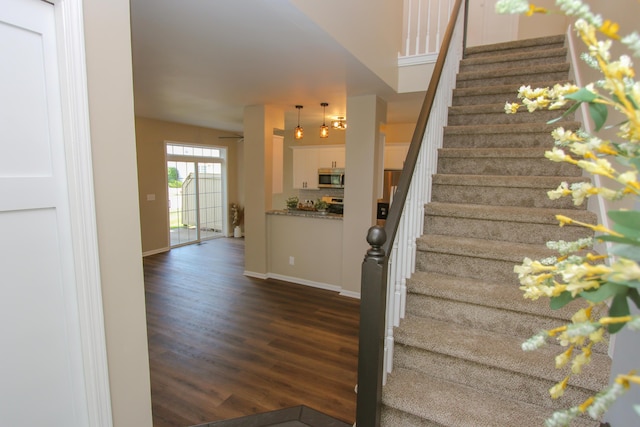 3216 E Morgan Creek Ct, Indiana, IN 46385 - staircase with wood finished floors and baseboards