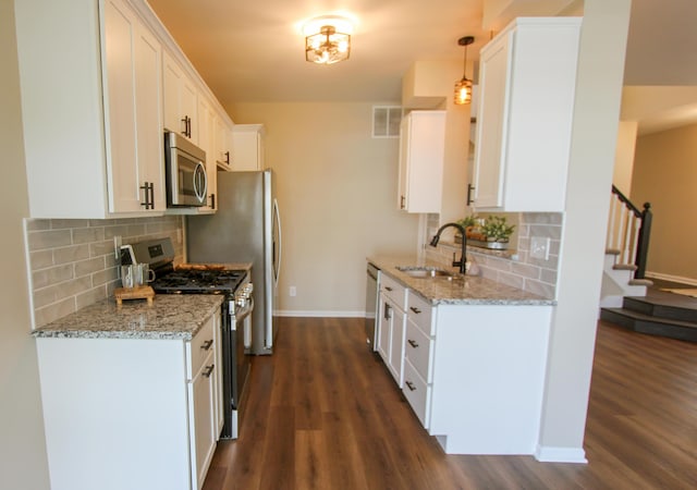 3216 E Morgan Creek Ct, Indiana, IN 46385 - kitchen with appliances with stainless steel finishes, dark wood-style flooring, backsplash, and white cabinets