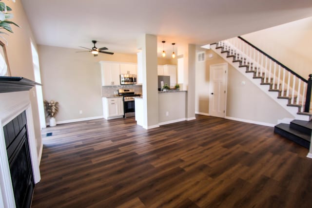 3216 E Morgan Creek Ct, Indiana, IN 46385 - unfurnished living room with a fireplace, stairway, dark wood-style flooring, and a ceiling fan