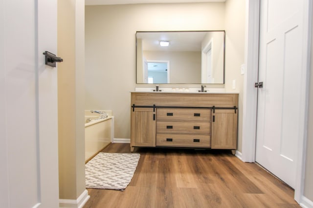 3216 E Morgan Creek Ct, Indiana, IN 46385 - bathroom featuring double vanity, wood finished floors, and a garden tub