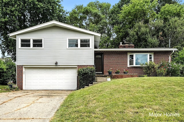 1435 Sweet St NE, Grand Rapids, MI 49505 - tri-level home with brick siding, a garage, a front lawn, concrete driveway, and a chimney
