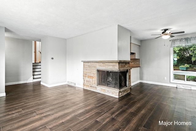 1435 Sweet St NE, Grand Rapids, MI 49505 - unfurnished living room with ceiling fan, wood finished floors, a fireplace, and stairway