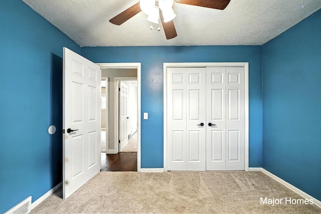 1435 Sweet St NE, Grand Rapids, MI 49505 - unfurnished bedroom with carpet floors, a textured ceiling, a closet, and ceiling fan