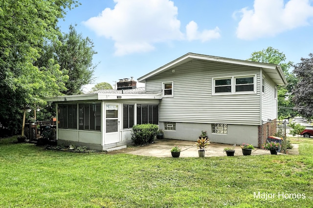 1435 Sweet St NE, Grand Rapids, MI 49505 - rear view of house featuring a sunroom, a patio area, a yard, and a chimney