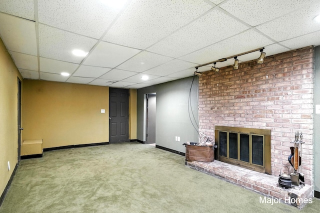 1435 Sweet St NE, Grand Rapids, MI 49505 - unfurnished living room featuring carpet, a drop ceiling, a fireplace, track lighting, and recessed lighting