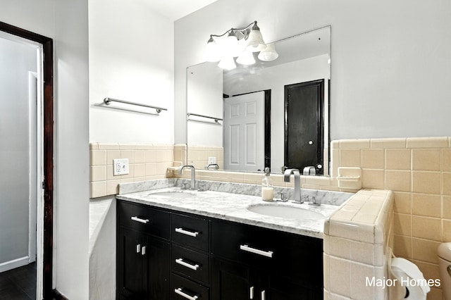 1435 Sweet St NE, Grand Rapids, MI 49505 - bathroom featuring tile walls and double vanity