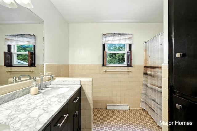 1435 Sweet St NE, Grand Rapids, MI 49505 - full bathroom featuring tile walls, plenty of natural light, vanity, a wainscoted wall, and a shower with curtain