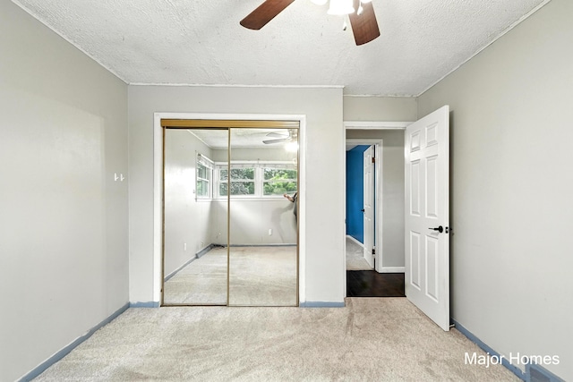 1435 Sweet St NE, Grand Rapids, MI 49505 - unfurnished bedroom with carpet floors, a closet, a textured ceiling, and a ceiling fan