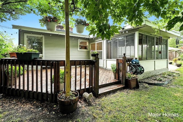1435 Sweet St NE, Grand Rapids, MI 49505 - rear view of property featuring a sunroom and a wooden deck
