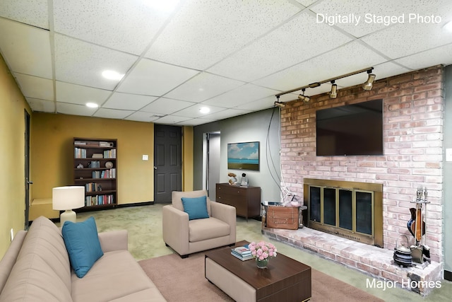 1435 Sweet St NE, Grand Rapids, MI 49505 - living area featuring track lighting, a drop ceiling, carpet flooring, a fireplace, and recessed lighting