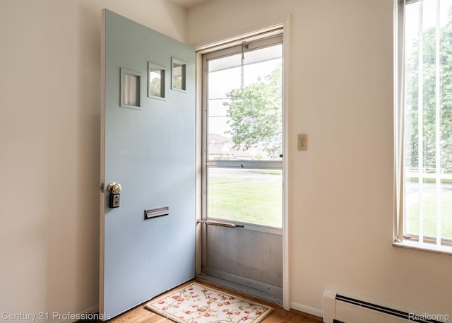 5959 Alan Dr # 56, Brighton, MI 48116 - entryway with a baseboard heating unit, healthy amount of natural light, and wood finished floors